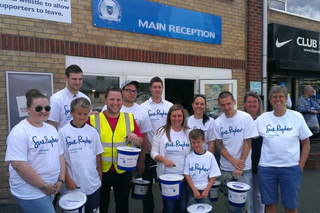 BGL colleagues and their families holding a collection for Sue Ryder outside Peterborough United in August, 2018.