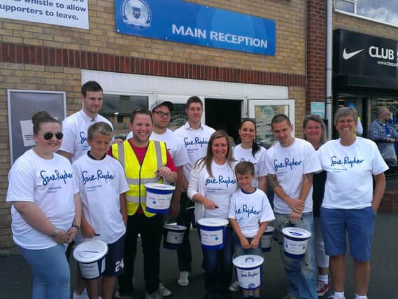BGL colleagues and their families holding a collection for Sue Ryder outside Peterborough United in August, 2018.
