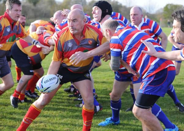 Tony McClure on the attack for the Juggers against Old Deaconians.