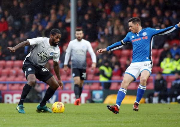 Posh man of the match Anthony Grant is confronted by Rochdale's Ian Henderson. Photo: Joe Dent/theposh.com.