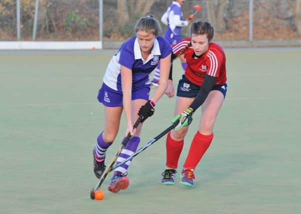 City of Peterborough's Lucy Dakin (red) battles for possession against Sevenoaks. Photo: David Lowndes.