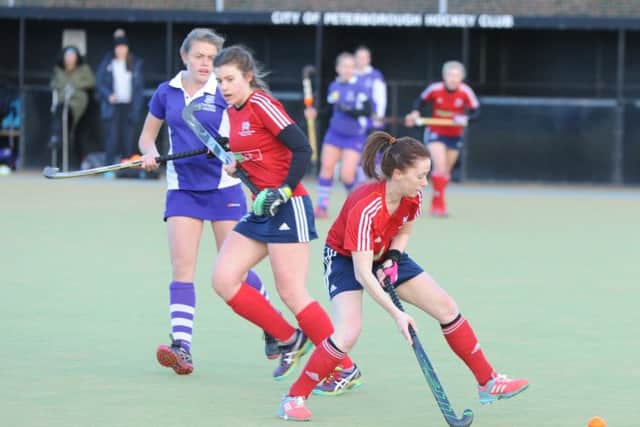 Mel Ludlam on the ball for City of Peterborough Ladies (red) against Sevenoaks. Photo: David Lowndes.