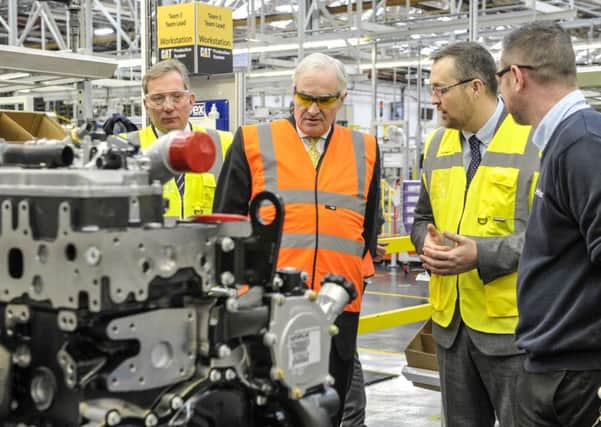 Business minister Lord Henley (in orange top) visits Caterpillar in Peterborough.