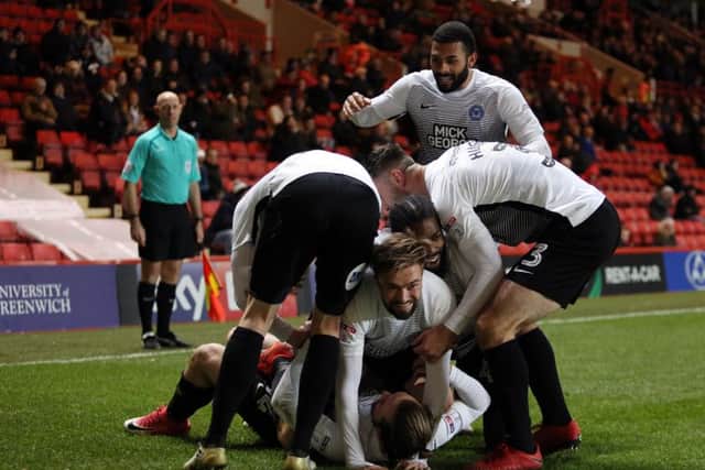 Posh top scorer Jack Marriott is mobbed by his team-mates afrer scoring at Charlton. Photo: Joe Dent/theposh.com.