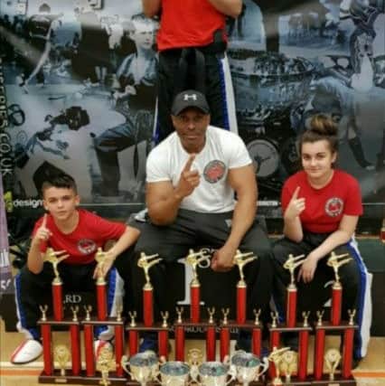 Robert Taylor with his champions Grant Brown (back), Brayden Popat Evans (left) and Jazmyn Popat Evans (right).