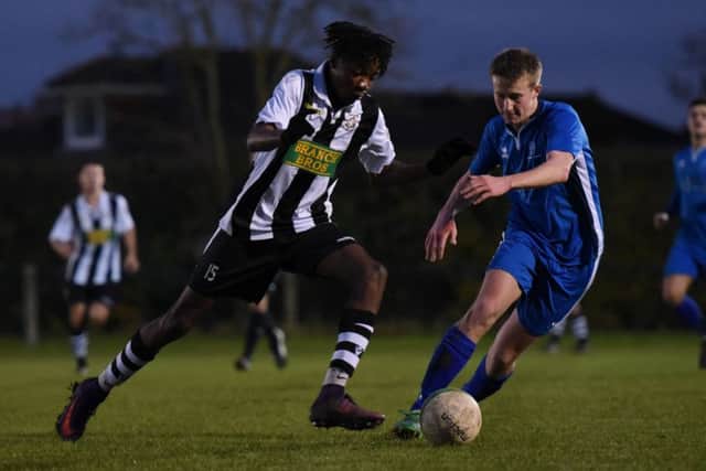 Tiago Nassunculo (stripes) of Peterborough Northern Star in action against Cogenhoe United last weekend. Photo: Chantelle McDonald. @cmcdphotos.