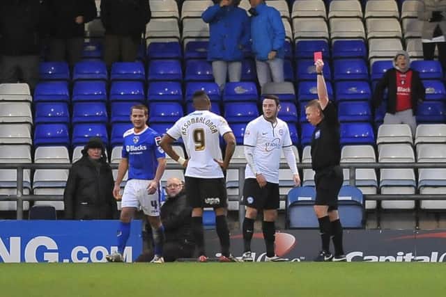 Posh star Lee Tomlin is sent off at Oldham.