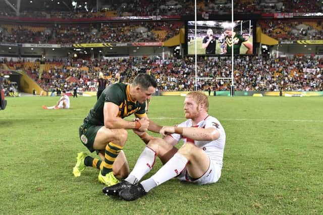 England's Jamie Graham is consoled by Australia's Cooper Cronk after a dull Rugby League World Cup Final.