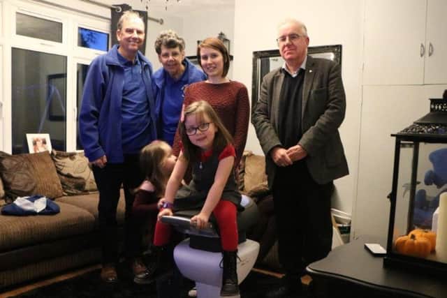 Faith McLennan on her iJoy Ride with, from left, Lions Vince and Carol Sterland, sister Tayla , mum Caroline Brewster and Rotary president Alan Kendrick.