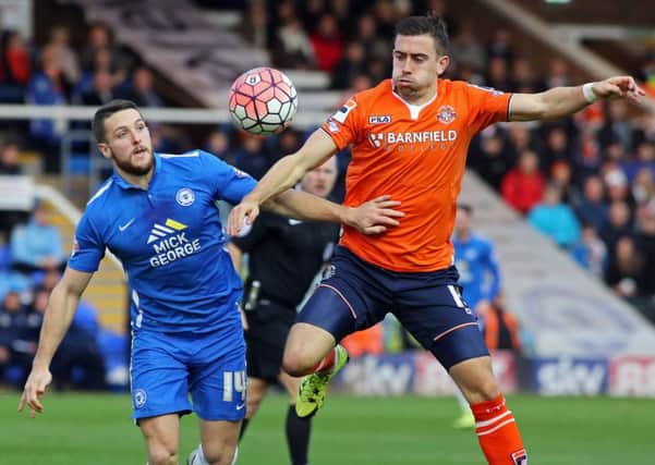 Conor Washington of Peterborough United in action with Oliver Lee of Luton Town in December 2015.