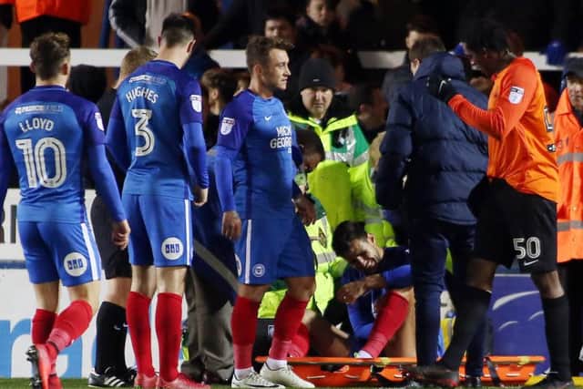 Ryan Tafazolli of Peterborough United winces in pain after injuring his knee against Southend United. Picture: Joe Dent