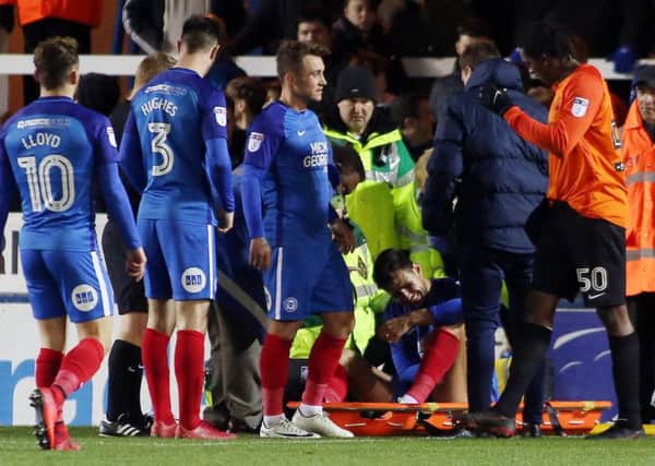 Ryan Tafazolli of Peterborough United winces in pain after injuring his knee against Southend United. Picture: Joe Dent