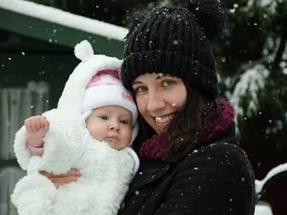 Gemma Smith with her daughter Luna experiencing her first snowfall