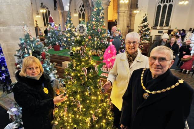 The annual Whittlesey Extravaganza on the Market Place.  Julie Windle (deputy Mayor of Whittlesey) with Pat Butcher (Mayoress) and Mayor  Ralph Butcher looking at the CHristmas Tree festival at St Mary's Church. EMN-170812-192746009