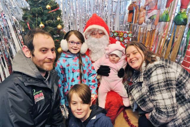 The annual Whittlesey Extravaganza on the Market Place.  The Johnson family meet Father Christmas EMN-170812-192854009
