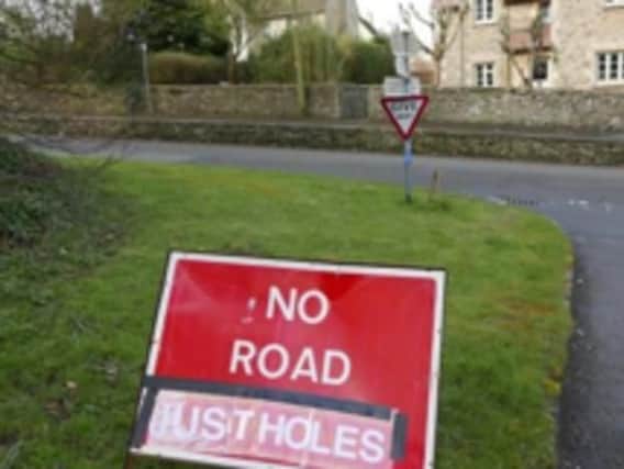 A Gloucestershire pothole vigilante got creative and made fake road signs to shame their local council into sorting crumbling road surfaces. Their escapades included changing a No Road Markings warning to read No Road, Just Holes and she even went as far as having a sign made saying CAUTION THIRD WORLD ROADS AHEAD after nearly ten villagers experienced car damage due to potholes in the area. (Photo credit  Wilts Glos Standard)