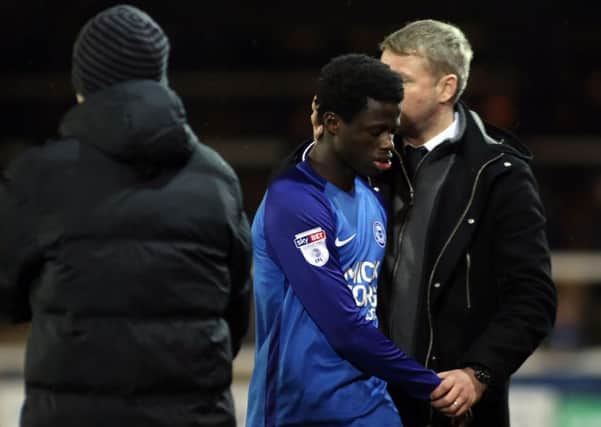Posh teenager Leo Da Silva Lopes is consoled by manager Grant McCann.