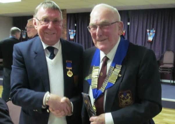 New Peterborough League president Dick Gill (right) received the chain of office from outgoing president Bruce Saint.