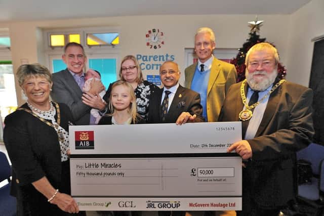 Little Miracles £50,000 cheque pres.Mayor of Peterborough Coun. John Fox and Mayoress Judy Fox with High Sheriffs Vinod Tailor and Richard Pemberton , Michelle King and daughter Imogen and sponsor Denis Nolan holding baby Justice. EMN-171212-162941009