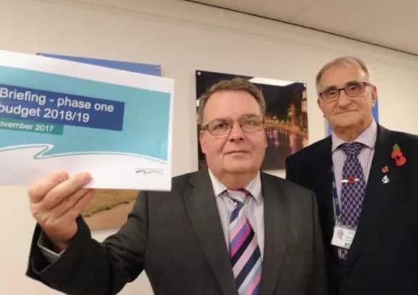 Cabinet member for resources Cllr David Seaton holding budget proposals alongside council leader Cllr John Holdich