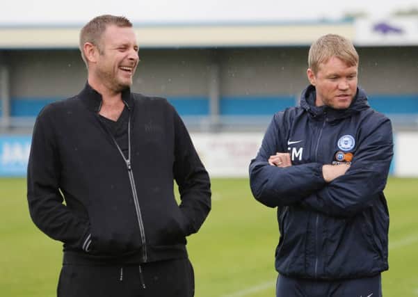 Posh chairman Darragh MacAnthony and manager Grant McCann (right).