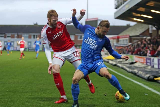 Danny Lloyd of Peterborough United battles for the ball with Cian Bolger of Fleetwood.  Photo: Joe Dent/theposh.com.