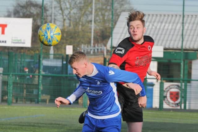 Action from Netherton's 6-0 win over Warboys (blue). Photo: David Lowndes.