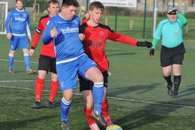 Action from Netherton's easy win in the Peterborough Premier Division against Warboys (blue): Photo; David Lowndes.