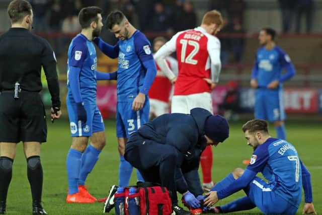 Posh midfielder Gwion Edwards receives treatment on his ankle injury at Fleetwood.  Photo: Joe Dent/theposh.com.
