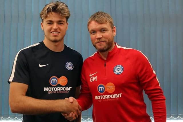 Sam Cartwright (left) with Posh manager Grant McCann after signing his professional deal.