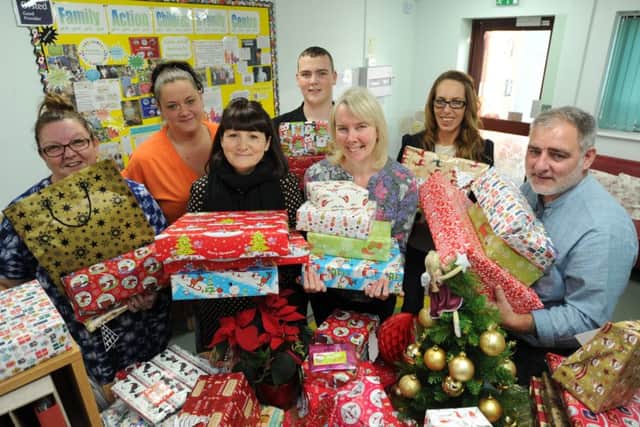 Jamie Turner and Jon Blundell with Christmas presents from Stamford St Martin's Rotary given to Family Action children and family centre Peterborough at Hampton representatives Sally Greiff, Gemma Douglas, Sally Chalfont, Carol Ward and Sam Bidgood. EMN-171218-230406009