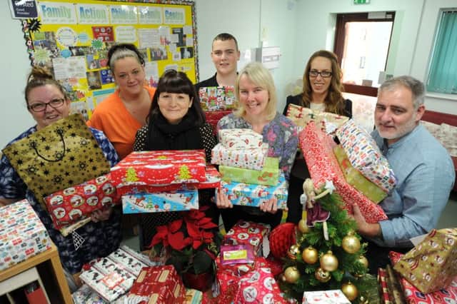 Jamie Turner and Jon Blundell with Christmas presents from Stamford St Martin's Rotary given to Family Action children and family centre Peterborough at Hampton representatives  Sally  Greiff, Gemma Douglas, Sally Chalfont, Carol Ward and Sam Bidgood. EMN-171218-230406009