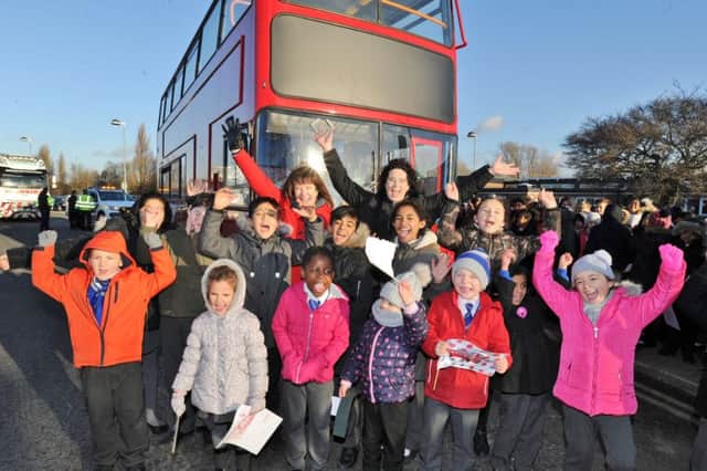 Pupils from St Thomas More RC primary school out to welcome the arrival of their double decker bus which is to be converted into a library. EMN-170812-192603009