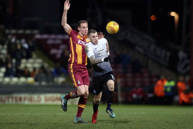Posh attacker Marcus Maddison runs away from Bradford defender Matthew Killgallon. Photo: Joe Dent/theposh.com.