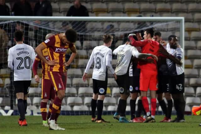 Posh players celebrate together after victory at Bradford City is confirmed. Photo: Joe Dent/theposh.com.