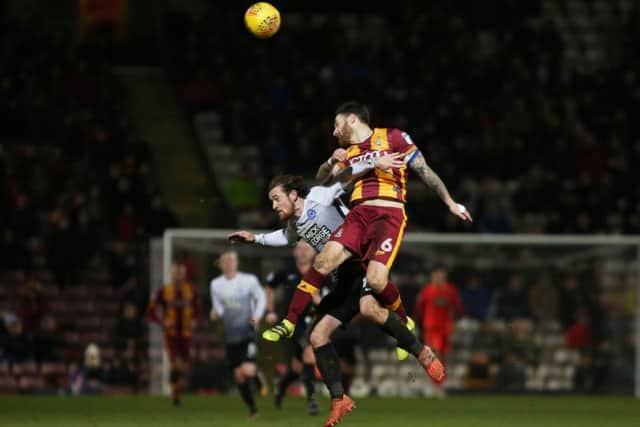 Posh striker Jack Marriott is beaten in the air by Romain Vincelot. Photo: Joe Dent/theposh.com.