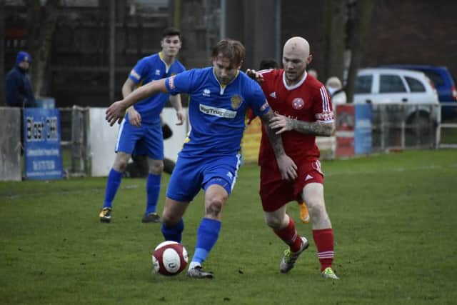 Lewis Webb (red) in action for Peterborough Sports at Spalding. Photo: James Richardson.