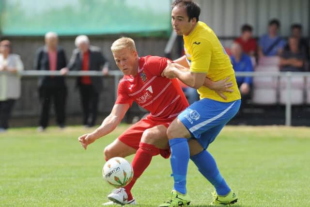 Michael Frew (red) scored twice for Wisbech against Holbeach.
