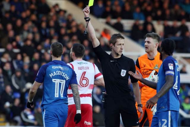 Referee John Brooks cautions Posh star Marcus Maddison for simulation. Photo: Joe Dent/theposh.com.