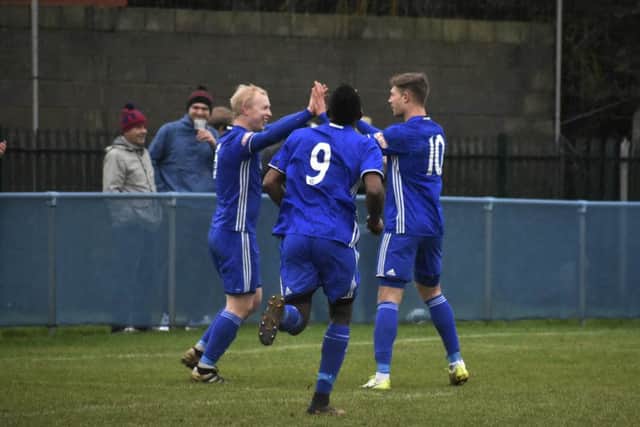 Lewis Hilliard (left) is congratulated after scoring from the penalty spot for Peterborough Sports against Stamford. Photo: James Richardson.