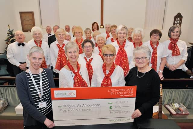 Jenny  Mosley, MAGPAS finance officer receives a cheque from Marjorie Richardson and the Yaxley Singers at Yaxley methodist church. EMN-171216-103625009