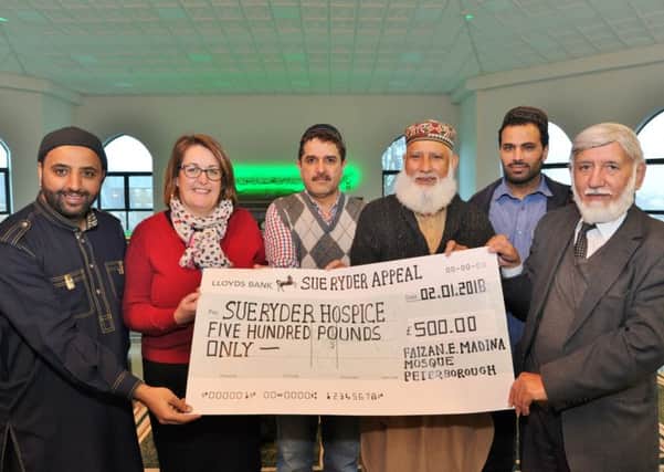 Sue Ryder director Allison Mann receives a cheque from Zesham Ahmed, Dr Muhammad Nawaz, Muhammad Younas, secretary, Zahid Akbar and Abdul Choudhuri, chairman, of Faizan-e-Medinah mosque to replace stolen cash from the hospice. EMN-180201-173705009