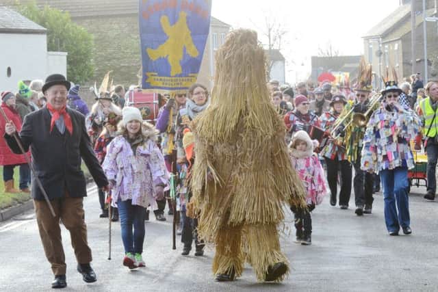Straw Bear Festival 2017 at Whittlesey. Straw Bear and his keeper leading the parade EMN-170114-174446009