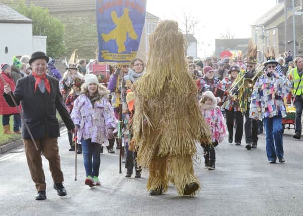 Straw Bear Festival 2017 at Whittlesey. Straw Bear and his keeper leading the parade EMN-170114-174446009