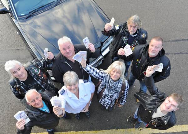 Judith Harvey, community programme manager at the Peterborough Salvation Army Citadel receives cash donation from members of the Ace of Spades motorcycle club -  club president "Dodo" with Alicja Homan, Nick Barnard, Steve Cox, Kev Morrell, Donydas Rumkis and Steve Dobshaw EMN-170312-094247009