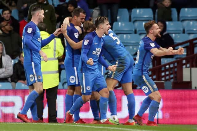 Danny Lloyd (right) leads the Posh celebrations after the third goal in a 3-1 win at Aston Villa. Photo: Joe Dent/theposh.com.