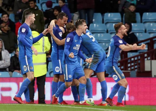 Danny Lloyd (right) leads the Posh celebrations after the third goal in a 3-1 win at Aston Villa. Photo: Joe Dent/theposh.com.