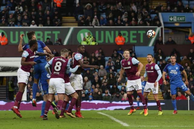 Ryan Tafazolli heads Posh in front at Villa Park. Picture: Joe Dent/theposh.com.