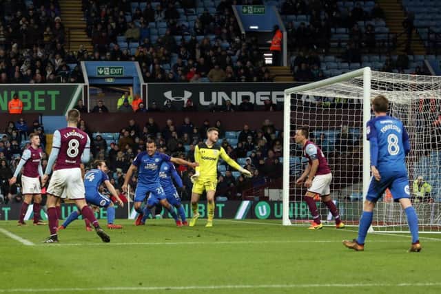 Posh striker Jack Marriott (14) heads his side level at Aston Villa to the delight of Steven Taylor and the despair of John Terry (right). Picture: Joe Dent/theposh.com.