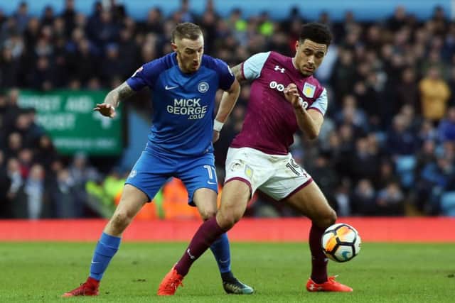 Posh star Marcus Maddison challenges Villa's Andre Green. Photo: Joe Dent/theposh.com.